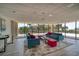 Comfortable lounge area with sofas, ottomans, and floor-to-ceiling windows with views of the outdoors at 7600 Bayshore Dr # 204, Treasure Island, FL 33706