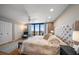 Bright main bedroom with a tufted headboard, ocean view, and natural light at 7600 Bayshore Dr # 204, Treasure Island, FL 33706
