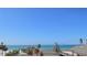 Stunning ocean view showcasing palm trees, a beachside building, and the serene blue sea at 7600 Bayshore Dr # 204, Treasure Island, FL 33706