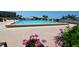 Inviting pool area surrounded by colorful flowers and lush landscaping, perfect for relaxation at 7600 Bayshore Dr # 204, Treasure Island, FL 33706