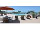 Relaxing poolside view with comfortable lounge chairs and beautiful ocean scenery at 7600 Bayshore Dr # 204, Treasure Island, FL 33706