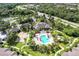 Aerial view of the community clubhouse, pool, and beautifully landscaped grounds at 8926 Manor Loop # 207, Lakewood Ranch, FL 34202