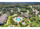 Overhead view of the community featuring a pool, clubhouse, and verdant surroundings at 8926 Manor Loop # 207, Lakewood Ranch, FL 34202