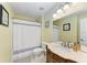 Stylish bathroom featuring a vanity with marble countertop, toilet, and shower with a decorative shower curtain at 8926 Manor Loop # 207, Lakewood Ranch, FL 34202