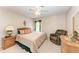 Inviting bedroom features a comfortable bed, window with curtains, and a cozy reading chair for relaxation at 8926 Manor Loop # 207, Lakewood Ranch, FL 34202