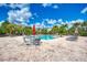 Sparkling community pool surrounded by comfortable lounge chairs and tropical landscaping at 8926 Manor Loop # 207, Lakewood Ranch, FL 34202