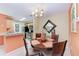 Eat-in dining area with wood table, chandelier and view into the stainless-steel kitchen at 8926 Manor Loop # 207, Lakewood Ranch, FL 34202