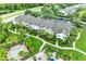 Up close exterior view of townhomes with sidewalks, lush green grass, trimmed bushes and tropical palm trees at 8926 Manor Loop # 207, Lakewood Ranch, FL 34202