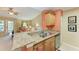 Well-equipped kitchen features granite countertops, stainless steel appliances, and a breakfast bar overlooking the living area at 8926 Manor Loop # 207, Lakewood Ranch, FL 34202