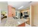 Kitchen with granite counters, stainless steel appliances, and access to the bedroom at 8926 Manor Loop # 207, Lakewood Ranch, FL 34202