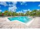 Large community swimming pool with plenty of deck space, tables, and palm trees at 8926 Manor Loop # 207, Lakewood Ranch, FL 34202