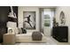 A stylish bedroom with a neutral color palette, and a comfortable bed with modern decor at 9705 Runaway Breeze Dr, Land O Lakes, FL 34637