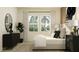 A cozy bedroom features a large window, stylish dresser, and comfortable bed with decorative pillows at 9705 Runaway Breeze Dr, Land O Lakes, FL 34637