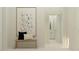 Bright entryway featuring neutral decor, modern art, and seating bench near the entryway at 9705 Runaway Breeze Dr, Land O Lakes, FL 34637