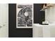 Clean laundry room with black accent wall, modern art, wire shelf, and modern appliances at 9705 Runaway Breeze Dr, Land O Lakes, FL 34637