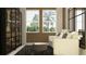 Bright living room featuring stylish chairs, modern bookcase, an accent ottoman, and ample natural light at 9705 Runaway Breeze Dr, Land O Lakes, FL 34637
