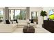 Bright living room featuring a plush sectional sofa, stylish coffee table, and large windows for natural light at 9705 Runaway Breeze Dr, Land O Lakes, FL 34637