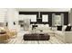 This living room area is open to the modern kitchen, creating an inviting space for relaxation and entertainment at 9705 Runaway Breeze Dr, Land O Lakes, FL 34637