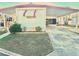 Exterior view of the home featuring a covered carport, well-maintained lawn, and classic design at 9790 66Th N St # 206, Pinellas Park, FL 33782