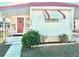 Charming single-story home featuring a covered front porch, white siding, and well-maintained landscaping at 9790 66Th N St # 206, Pinellas Park, FL 33782