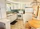 Cozy kitchen with white cabinetry, tile flooring, and dining table, perfect for casual meals at 9790 66Th N St # 206, Pinellas Park, FL 33782