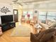 Bright living room with wood floors, ample seating, and plenty of natural light at 9790 66Th N St # 206, Pinellas Park, FL 33782
