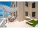 Expansive balcony with ocean views featuring a dining area, lounge furniture, and a cornhole game at 10 Papaya St # 1404, Clearwater Beach, FL 33767