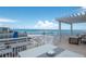 Large balcony with dining and seating with views of the beach and pier at 10 Papaya St # 1404, Clearwater Beach, FL 33767