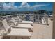 Relaxing balcony view with lounge chairs overlooking the city skyline and harbor views at 10 Papaya St # 1404, Clearwater Beach, FL 33767