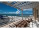 Enjoy beautiful ocean and beach views from this balcony featuring a dining table and comfortable outdoor seating at 10 Papaya St # 1404, Clearwater Beach, FL 33767