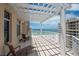 Inviting balcony featuring a pergola, tile flooring, lounge chairs and a stunning ocean view at 10 Papaya St # 1404, Clearwater Beach, FL 33767