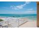 Beautiful beach view from a balcony, featuring white sands, clear waters, and a fishing pier at 10 Papaya St # 1404, Clearwater Beach, FL 33767