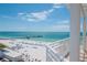 Beautiful beach view from a balcony, showcasing white sands, clear waters, and a fishing pier at 10 Papaya St # 1404, Clearwater Beach, FL 33767