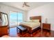 Inviting bedroom with hardwood floors and a balcony offering breathtaking ocean views, creating a tranquil retreat at 10 Papaya St # 1404, Clearwater Beach, FL 33767