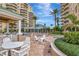 Tropical courtyard offers outdoor lounge seating with a beautiful pool and spa nearby at 10 Papaya St # 1404, Clearwater Beach, FL 33767