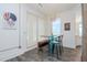 Bright dining area features a glass table, seating bench, modern lighting, and an interesting piece of art at 10 Papaya St # 1404, Clearwater Beach, FL 33767