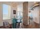 A modern dining area with glass table and industrial-style accents flows into the open kitchen at 10 Papaya St # 1404, Clearwater Beach, FL 33767