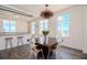 Dining room featuring a dark wood table set, modern light fixtures, and bright light from large windows at 10 Papaya St # 1404, Clearwater Beach, FL 33767