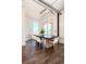 Bright dining room featuring a long dark wood table and modern crystal chandelier at 10 Papaya St # 1404, Clearwater Beach, FL 33767