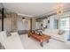 Bright and airy living room featuring modern decor, industrial ductwork, and a custom wood coffee table at 10 Papaya St # 1404, Clearwater Beach, FL 33767