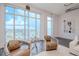 Living room with large windows showcasing city views and decorative chairs at 10 Papaya St # 1404, Clearwater Beach, FL 33767