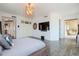 Spacious main bedroom featuring a modern chandelier, large windows, and walk-out balcony at 10 Papaya St # 1404, Clearwater Beach, FL 33767