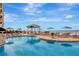 Resort-style pool overlooking the ocean with lounge chairs and umbrellas for relaxation at 10 Papaya St # 1404, Clearwater Beach, FL 33767