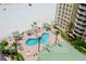 Aerial view of the pool with lush landscaping and beach access at 10 Papaya St # 1404, Clearwater Beach, FL 33767