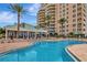 Gorgeous pool with sun loungers with palm trees with nearby outdoor seating for resort living at 10 Papaya St # 1404, Clearwater Beach, FL 33767