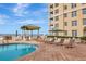 Community swimming pool with chairs and beach views at 10 Papaya St # 1404, Clearwater Beach, FL 33767