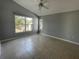 This spacious bedroom features tile floors and a large window with lots of natural light at 10127 Barnett Loop, Port Richey, FL 34668