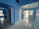 Bright foyer with tile flooring, featuring a view of the front door and access to other rooms at 10127 Barnett Loop, Port Richey, FL 34668