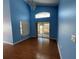 Open living room featuring a sliding door to the lanai and ample natural light at 10127 Barnett Loop, Port Richey, FL 34668