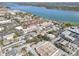 Expansive aerial shot showcasing the community, the adjacent lake, and nearby commercial areas at 10540 77Th Ter # 209, Seminole, FL 33772